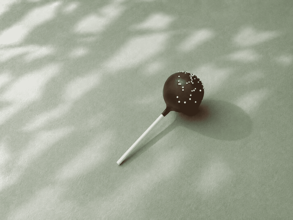 Starbucks Chocolate Cake Pop with chocolate icing and white sprinkles